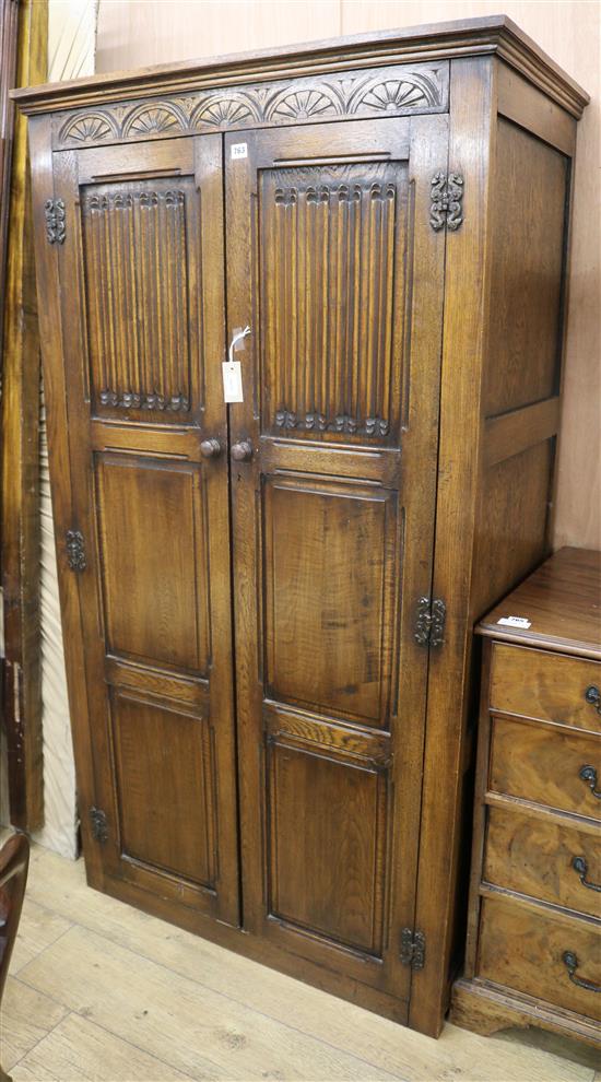 A carved and panelled oak wardrobe, W.96cm